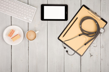 workplace of doctor - stethoscope, clipboard, tablet pc