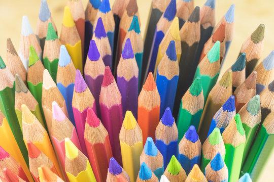 The large number of disordered multicolored crayons. Photographed from a larger angle.