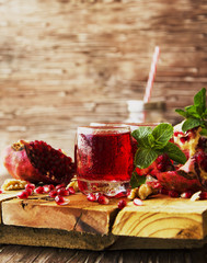 Fresh pomegranates and juice, selective focus