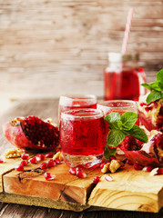 Fresh pomegranates and juice, selective focus