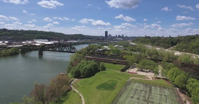 A slowly moving shot of the Pittsburgh skyline as seen from the air above Washington's Landing.  	