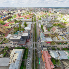 Fototapeta premium Aerial city view with crossroads and roads, houses, buildings, parks and parking lots, bridges. Copter shot. Panoramic image.