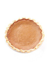 close-up overhead view of pumpkin pie over white background.