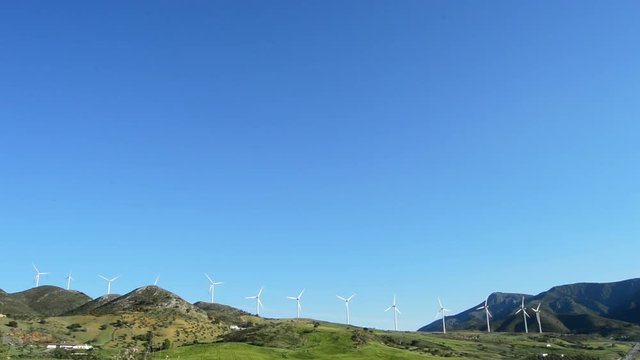 Landscape of wind turbines energy in a green field at sunny day