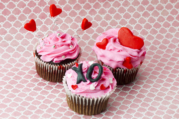 view of three strawberry cupcake with heart shape.