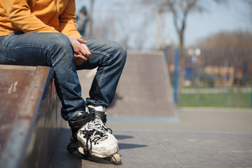 Rollerblader sitting in aggressive inline skates