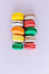 Sweet colorful French macaroon biscuits on pastel background, to