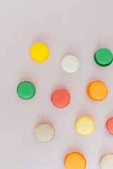 Sweet colorful French macaroon biscuits on pastel background, to