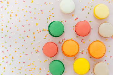 Sweet colorful French macaroon biscuits on pastel background, to