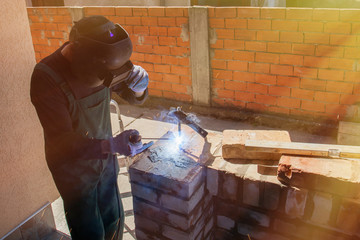 welder welds on the building site