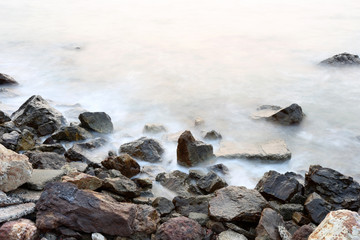 Sea mist softness of the tides and sunset at evening with rocks
