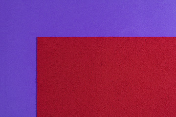 Eva foam ethylene vinyl acetate sponge plush red surface on purple smooth background