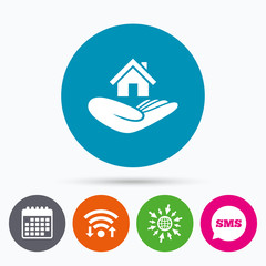 House insurance sign. Hand holds home symbol.