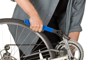Naklejka premium Man fixing pedals on a bicycle