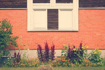 Vintage window on brick wall and garden underneath