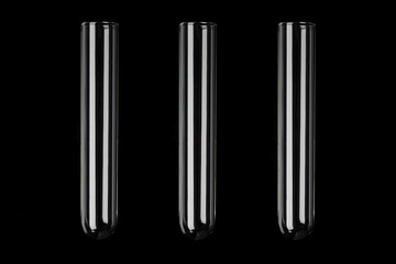 Three glass transparent test tubes on black background