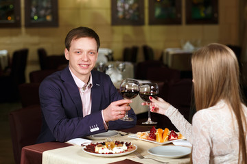 Couple toasting wineglasses in a luxury restaurant