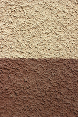 Half colored plaster texture wall. Exterior brown and beige stuc