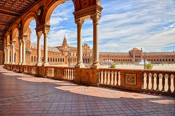 The famous Square of Spain, in Spanish Plaza de Espana, view from the path with columns, one example of the mixing Regionalism Architecture Renaissance and Moorish styles. Seville, Andalucia, Spain.