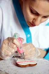 close-up of the process of hand-painted ginger cookies