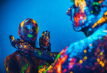 People are colored fluorescent powder. a pair of lovers dancing