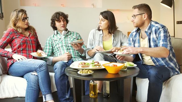 Friends eating lunch together and woman looking full

