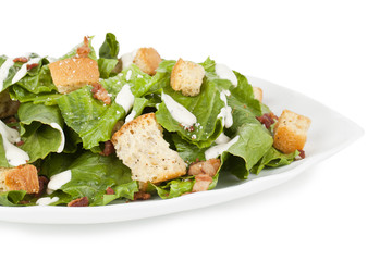 a plate with caesar salad