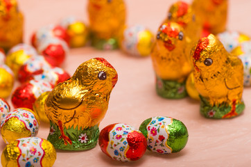 Easter chocolate little eggs andchicks covered in multicolor paper
