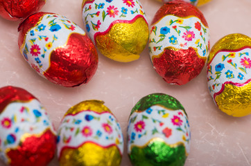 Easter chocolate little eggs andchicks covered in multicolor paper