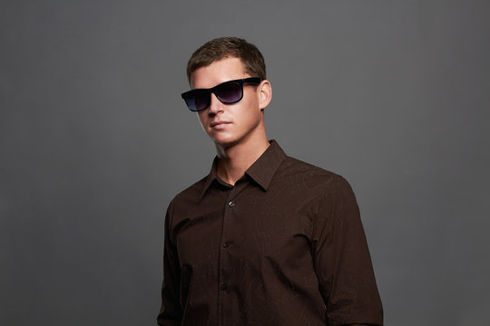 handsome man in sunglasses. Brutal boy in glasses