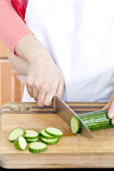 a human hand slicing bitter melon
