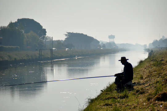 Fishing man in morning mist