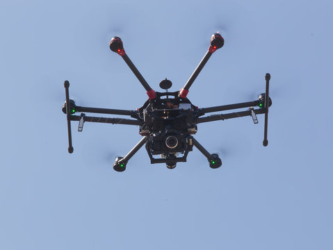 quadrocopter with camera flying in sky
