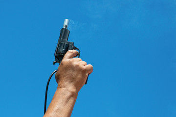 Starter.Hand firing a gun for starting race