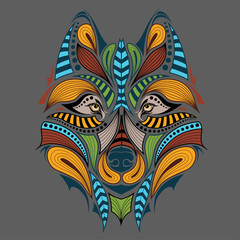 Patterned colored head of the wolf. African / indian / totem / tattoo design. It may be used for design of a t-shirt, bag, postcard and poster.