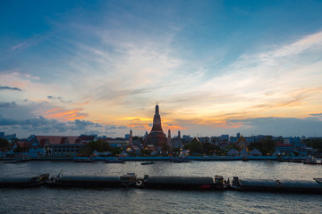 Fototapeta premium River and Wat Arun Temple during the sunset in Bangkok Thailand