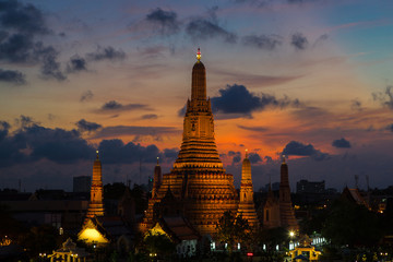 Fototapeta premium River and Wat Arun Temple at night in Bangkok Thailand