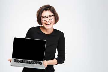Woman showing blank laptop computer screen