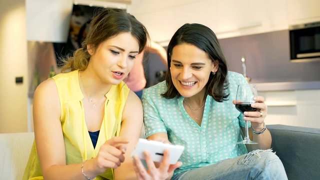 Women buying something via internet and smiling to the camera, steadycam shot
