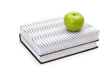 green apple on top of books