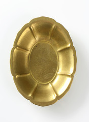 Obraz na płótnie Canvas Flower shaped golden metal bowl