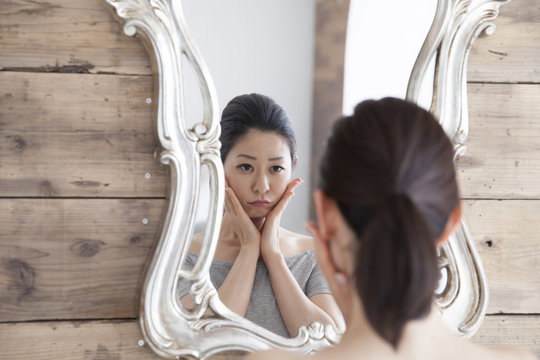 Women are thinking while looking in the mirror