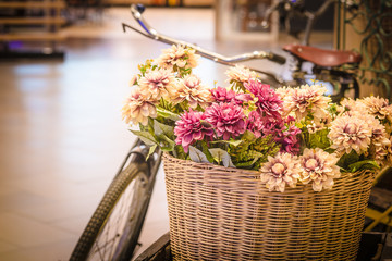 colorful flowers in basket and vintage bicycle