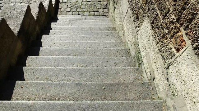 Going down steps and walking on cobblestone path along the banks of the river Seine, Paris, France