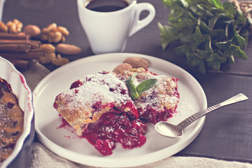 Cherry pie and a cup of coffee. Rustic style. Berry pie. Homemade cherry pie with flaky crust, cup of coffee, bowl with cherries