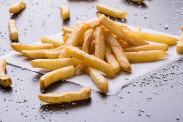 fries on a black table with sea salt