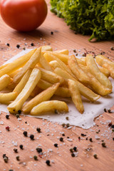 fries on a wooden table with seasoning