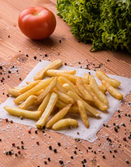 fries on a wooden table with seasoning