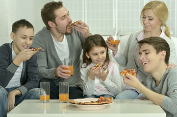 family at home with pizza