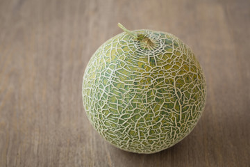 Melon with slices and on a wooden table